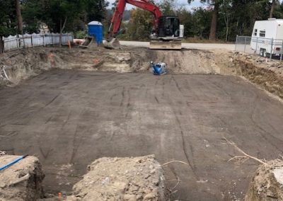 Toncar installing large concrete pad at residence