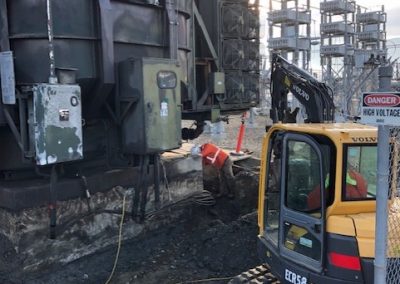 Toncar bulldozer near hydroelectric towers