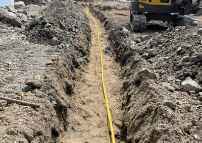 Toncar digging trench for yellow pipe